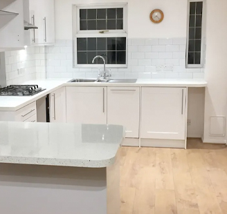 White kitchen with black stove