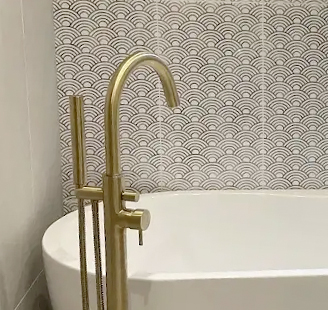 White bathtub with golden tap